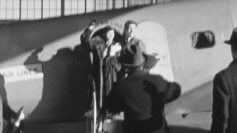 Couple-Poses-for-Photos-Upon-Arriving-to-their-First-Airplane-Flight-in-1930s