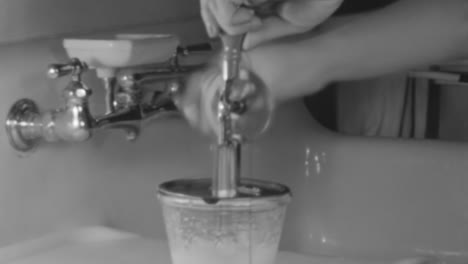 Woman-Makes-Cake-Frosting-with-an-Antique-Hand-Mixer-in-New-York-1930s