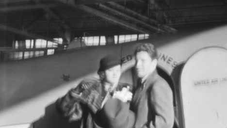 Beautiful-Woman-with-Her-Husband-Greets-Before-a-Plane-Trip-in-New-York-1930s