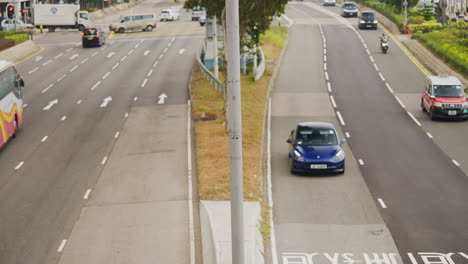 Captures-buses,-trucks-and-cars-driving-on-a-highway-in-Hong-Kong,-China