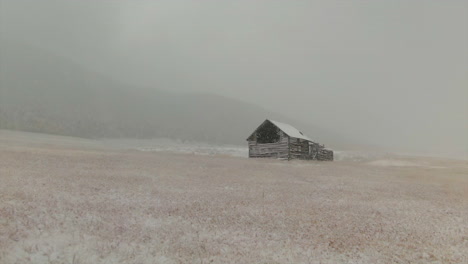 Open-Space-Evergreen-Colorado-first-snow-grassy-field-red-brown-horse-barn-aerial-drone-fall-autumn-winter-blizzard-snowy-Rocky-Mountain-front-range-Denver-historic-town-forward-upward-movement