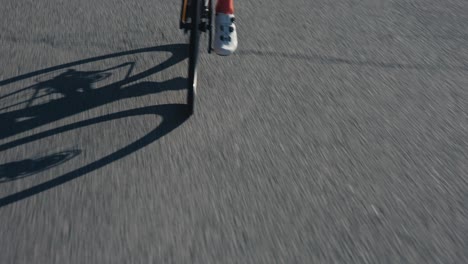 a-cyclist-man-riding-his-bike-in-the-mountains-on-a-road-in-full-gear-while-pedaling-fast