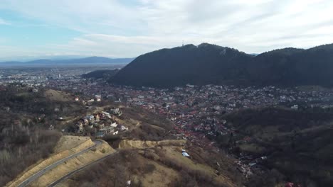 Aerial-shot-of-a-town-in-the-middle-of-the-dry-mountains-in-autumn