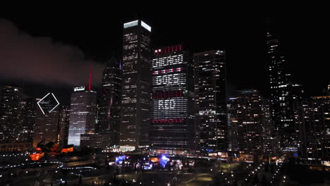 Aerial-view-around-the-illuminated-New-Eastside-skyline,-during-Chicago-Goes-Red