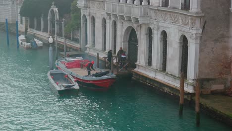 Early-morning-at-a-serene-Venetian-waterside-with-moored-boats