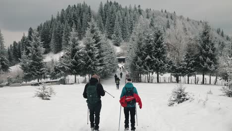 a-couple-hiking-on-a-winter-mountain