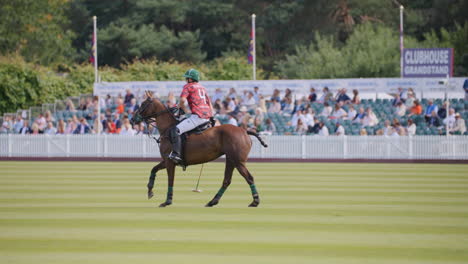 El-Jugador-De-Polo-Galopa-A-Caballo,-Cabalgando-En-Un-Campo-Verde,-Esperando-Que-Comience-El-Partido.