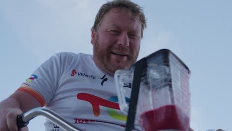 Closeup-view-of-a-man-riding-smoothie-bike-and-preparing-smoothie-at-Tour-de-France-in-France