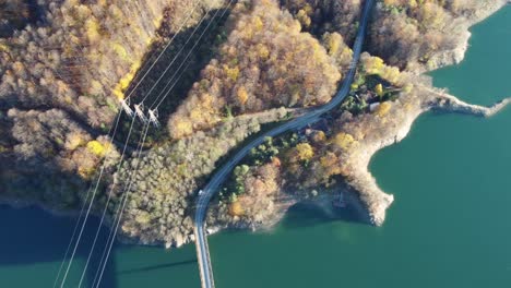 landscape-a-bridge-that-crosses-a-river-in-the-middle-of-mountains-with-electricity-pylons