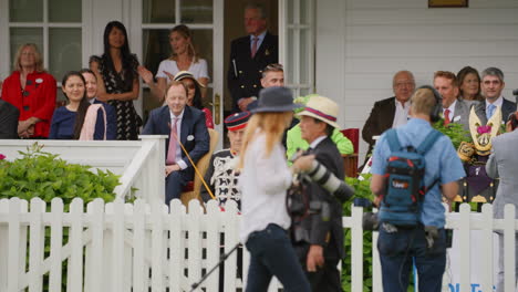 Queen-Elizabeth-in-a-green-dress-and-hat-sits-and-waits-for-the-driving-show-to-start