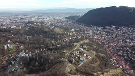 Aerial-shot-of-a-town-in-the-middle-of-the-dry-mountains-in-autumn