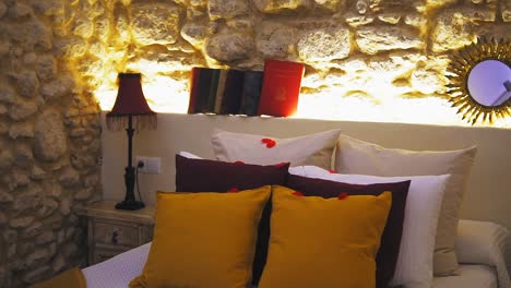 Modern-bedroom-interior-view-of-fresh-made-bed-with-pillows-and-rose-petals