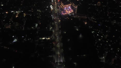 Moving-towards-Rajkot-aerial-drone-view-where-a-big-temple-is-visible-where-many-four-wheelers-and-bikes-are-going