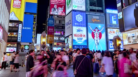 Night-Time-lapse-of-busy-crowds-and-Illuminated-signboards-at-Ebisubashi-Bridge-On-The-Dotonbori-Canal-Osaka,-Japan-TILT