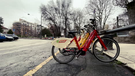 Bike-Mi,-public-transportation-bikes-parked-on-street-in-Milan,-Italy