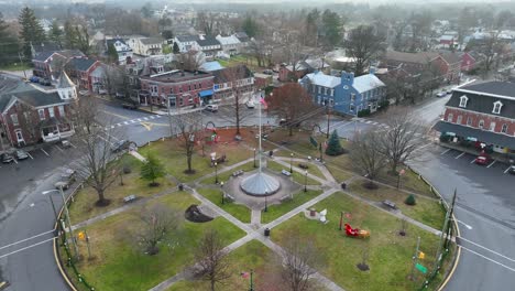 Approaching-flight-towards-american-flag-in-park-at-rainy-day