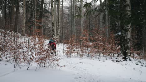 a-couple-hiking-on-a-winter-mountain