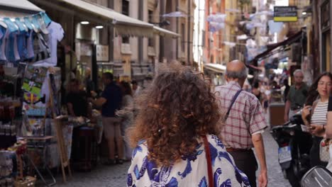 Bearded-man-rides-motor-scooter-up-congested-vibrant-Italian-cobbled-street