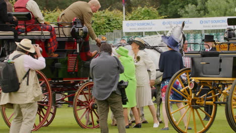 Queen-Elizabeth-reaches-up-to-present-trophy-to-winning-carriage-owner-at-annual-show