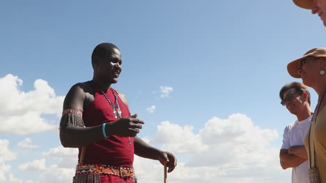 Group-Of-Tourists-Listening-To-A-Maasai-Man-In-Kenya,-Africa