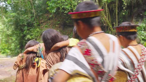 Indigenous-children-singing-and-dancing-near-a-river-in-Pucallpa,-Peru,-surrounded-by-lush-greenery