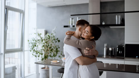 Young-couple-hugging-at-home