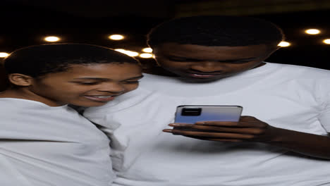 Couple-watching-video-on-device-at-the-street