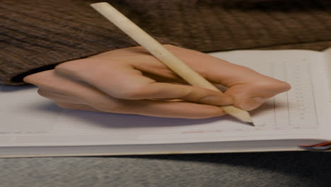 Person-writing-on-paper