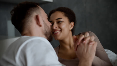 Lovely-couple-kissing-in-the-bedroom