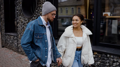 Young-couple-kissing-and-talking-on-the-street