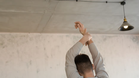 Man-stretching-indoors