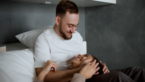 Sweet-couple-kissing-on-bed