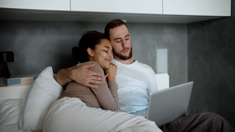 Lovely-couple-laying-on-bed