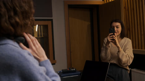 Woman-recording-with-smartphone