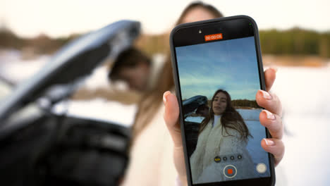 Girl-filming-her-boyfriend-and-herself-with-smartphone