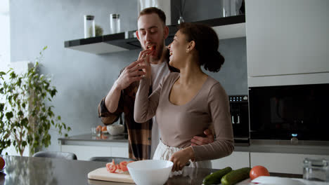 Man-hugging-his-girlfriend-in-the-kitchen