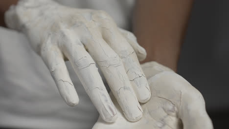 Person-removing-layer-of-paint-from-hands