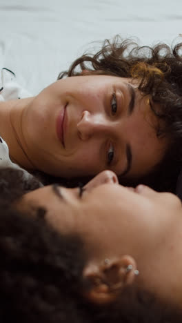 Happy-couple-talking-on-bed