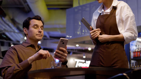 Waitress-attending-table-and-taking-notes