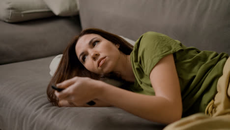 Woman-turning-off-the-TV-at-home