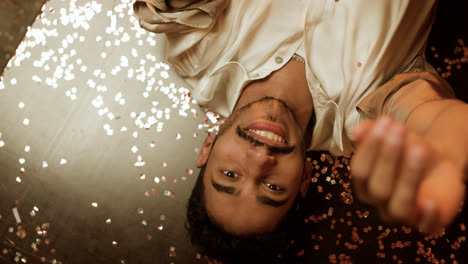 Happy-man-laying-on-the-floor-with-confetti