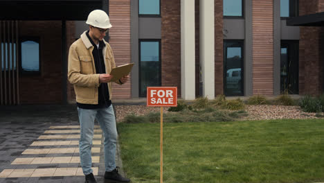 Man-checking-blueprints-on-clipboard