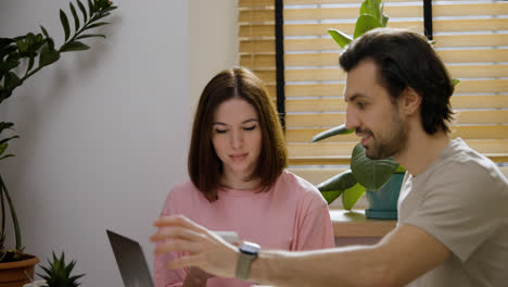 Couple-using-gadgets-at-home