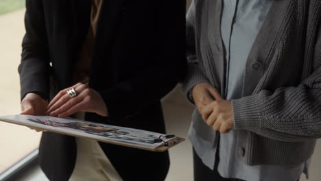 Woman-holding-clipboard-indoors