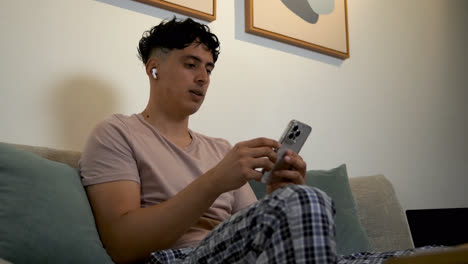 Young-man-with-earpods-at-home