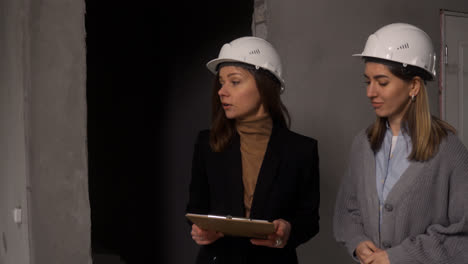 Women-with-hardhats-walking-in-house-under-construction