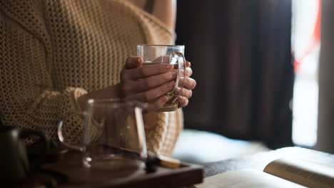 Person-holding-cup-of-tea