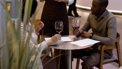 Waitress-attending-table-and-taking-notes