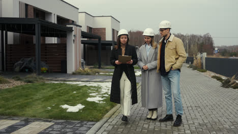 People-with-hardhats-talking-and-walking-outdoors