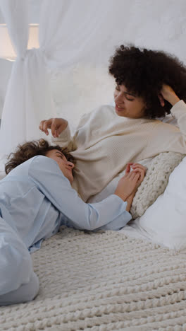 Happy-couple-talking-on-bed